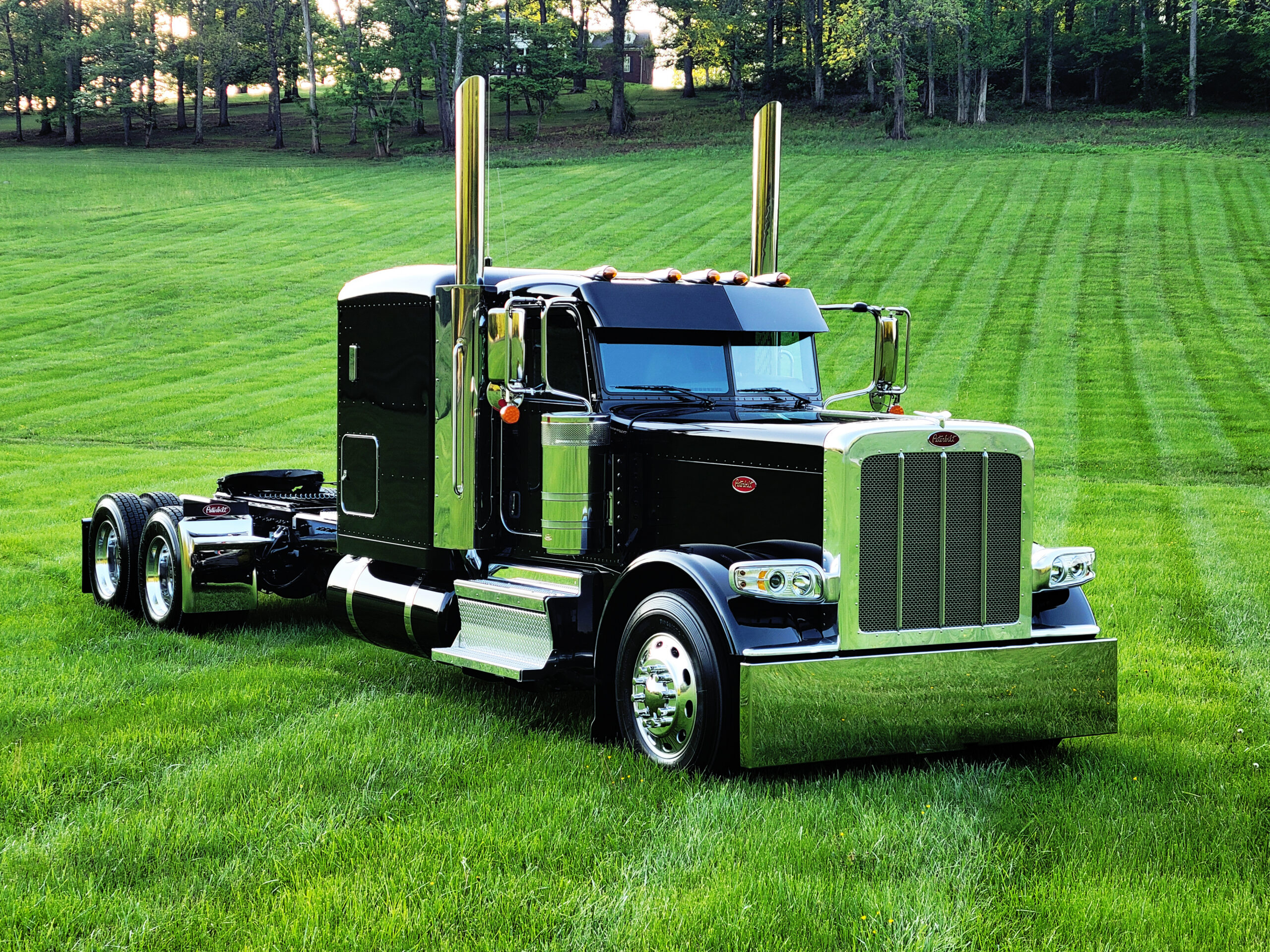 B&H Logistics truck in a grass field.